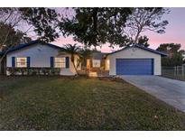 Charming single-story home with blue accents and a well-manicured lawn at 2076 Leanne Ct, Winter Park, FL 32792