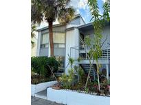 Charming two-story condo with lush landscaping and a private entrance, creating a welcoming curb appeal at 4322 Aqua Vista Dr # L, Orlando, FL 32839