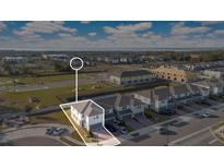 Aerial view of a new home community with a focus on a two-story house at 984 Desert Candle Dr, Ocoee, FL 34761