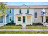 Charming two-story townhome with a welcoming front porch and well-maintained landscaping at 13730 Lensdale Ln, Windermere, FL 34786