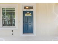 Blue front door entryway with sidelights and a porch at 13730 Lensdale Ln, Windermere, FL 34786