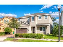 Two-story house with a brown garage door and landscaped lawn at 291 Lasso Dr, Kissimmee, FL 34747