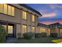Attractive two-story townhome with covered entry and landscaping at 5419 Fairwood Way # 305, Orlando, FL 32808
