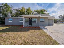 Gray house with a single-car garage and well-manicured lawn at 5624 Balboa Dr, Orlando, FL 32808