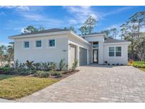 Single-story home with two-car garage and paver driveway at 1062 Liliana Dr, Deland, FL 32724