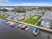 Aerial view of waterfront condo community with boat slips and recreational areas at 335 N Causeway # C23, New Smyrna Beach, FL 32169