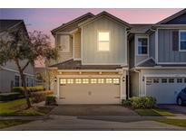 Two-story townhome with attached garage and landscaped front yard at 1008 E 10Th St, Apopka, FL 32703