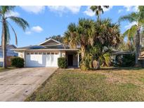 Single-story house with a white garage door and spacious lawn at 1194 Azora Dr, Deltona, FL 32725