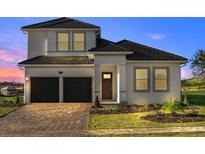 Two-story home with two-car garage and landscaped yard at 16000 Volterra Pt, Montverde, FL 34756