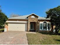 One-story house with stone accents and a two-car garage at 9714 Nonacrest Dr, Orlando, FL 32832