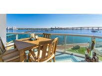 Waterfront balcony showcasing outdoor dining with beautiful views of the bay and city skyline at 241 Riverside Dr # 201, Daytona Beach, FL 32117
