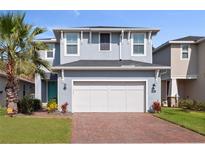 Charming two-story home with a well-maintained lawn, paver driveway, and attached two-car garage at 3804 Corona Ct, Sanford, FL 32773