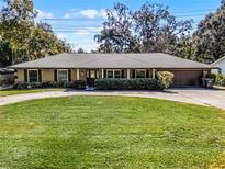 Ranch-style home with a large lawn and attached garage at 718 32Nd St, Orlando, FL 32806