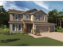 Two-story house with a stone facade, two-car garage, and landscaping at 7268 Dilly Lake Ave, Groveland, FL 34736