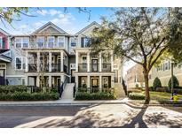 Three-story townhome with front porch and landscaping at 1197 Orange Ave, Winter Springs, FL 32708