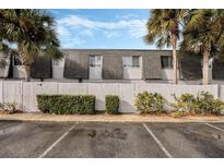 Charming townhome exterior with palm trees, fenced yard and ample parking at 1928 Conway Rd # 27, Orlando, FL 32812