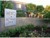 Community sign for Metro at Michigan Park amid lush landscaping and mature trees in front of the building at 1928 Conway Rd # 40, Orlando, FL 32812
