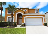 Two-story house with a large garage and palm trees in the front yard at 2793 Lido Key Dr, Kissimmee, FL 34747