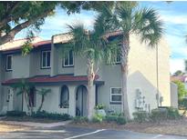 Inviting multi-level townhome with beautiful landscaping and mature palm trees at 3197 Sea World Ct, Kissimmee, FL 34746