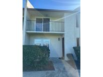 Two-story condo features a balcony, well maintained yard, and neutral color scheme at 607 Waverly Ln # 403, Maitland, FL 32751
