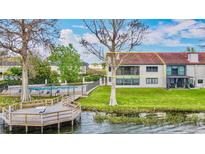 Waterfront home with balcony, community pool, private dock, and lush lawn at 660 Killarney Bay Ct # 6, Winter Park, FL 32789