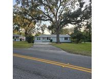 Charming single-story home with a well-manicured lawn and mature trees providing ample shade at 1026 Lake Jessamine Dr, Orlando, FL 32839