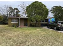 Ranch style home with a large front yard and mature trees at 110 Country Club Cir, Sanford, FL 32771