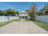 Charming two-story home features a manicured lawn, long driveway, and inviting front entrance at 1481 Harmon Ave, Winter Park, FL 32789