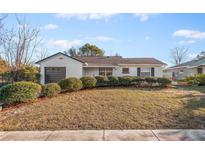 Charming single story home with landscaped lawn and updated garage door at 214 Sharp St, Apopka, FL 32712