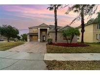 Two-story house with a paved driveway and landscaping at 5791 Covington Cove Way, Orlando, FL 32829