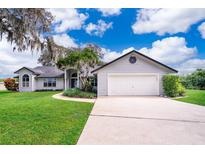 Gray house with a two-car garage and manicured lawn at 9012 Ogilvie Dr, Orlando, FL 32819