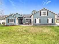 Charming home with a well-manicured lawn and beautiful landscaping creates great curb appeal at 10010 Crenshaw Cir, Clermont, FL 34711