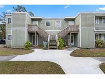 Two-story building with two units, each with its own staircase and small patio at 245 Scottsdale Sq # 245, Winter Park, FL 32792