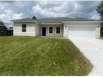 Newly constructed home with a two-car garage and grassy front yard at 2621 Sw 152Nd Ln, Ocala, FL 34473