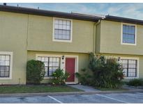 Charming townhome with neutral paint, red door, and manicured landscaping at 3208 Oak Lawn Pl # 218, Winter Park, FL 32792