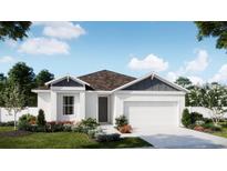 One-story home with white siding, brown roof, and landscaped yard at 426 Marion Loop, Haines City, FL 33844