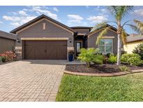 Beautiful single story home with manicured landscaping, a brick driveway and a two car garage at 508 Zamora Way, Davenport, FL 33837