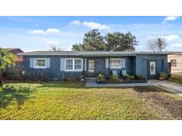 Charming single-story home featuring front yard, and covered front entry with decorative seating at 783 Cornelia Ct, Orlando, FL 32811