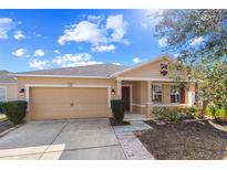 Charming single-Gathering home featuring a two-car garage and well-maintained landscaping in a sunny setting at 8008 Page Ct, Haines City, FL 33844
