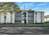 Building exterior featuring a two-story building with balconies and ample parking at 8217 Sun Spring Cir # 32, Orlando, FL 32825