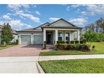 Charming single-Gathering home with a two-car garage and a brick-paved driveway, enhanced by verdant landscaping at 13557 Parkfield Way, Winter Garden, FL 34787