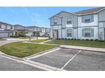 Two-story townhome with gray siding, landscaped lawn, and driveway parking at 3798 Lana Ave, Davenport, FL 33897