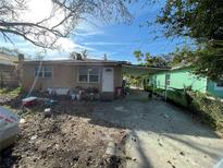 Tan single-story house with carport and small yard at 38 S Normandale Ave, Orlando, FL 32835