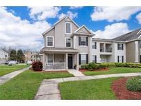 Two-story townhome with front porch and landscaping at 9141 Lee Vista Blvd # 305, Orlando, FL 32829