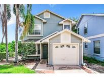 Charming two-story home with mature landscaping and attached garage at 9263 Lake Lotta Cir, Gotha, FL 34734