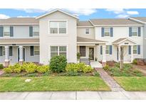 Beautiful townhome with neutral colors and a well-manicured lawn and flower beds at 11912 Boldface Dr, Orlando, FL 32832