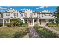 Charming townhome with landscaped front yard, brick walkway and covered front porch at 13829 Ingelnook Dr, Windermere, FL 34786