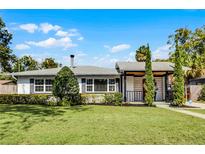 Charming single-story home featuring a well-maintained lawn and beautiful landscaping at 1911 Canton St, Orlando, FL 32803