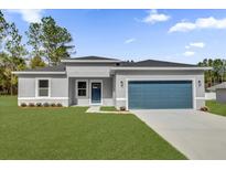 One-story home with gray siding, blue garage door, and landscaped lawn at 5757 Sw 128Th Pl, Ocala, FL 34473