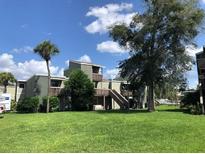 Two-story condo building with balconies and lush green lawn at 139 Scottsdale Sq # 139, Winter Park, FL 32792